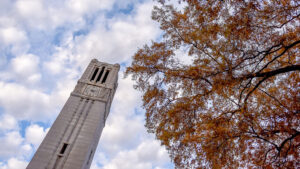 The NC State Memorial Belltower is framed by fall leaves. Photo by Becky Kirkland.