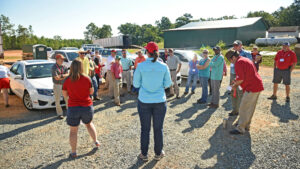 An N.C. Cooperative Extension agent speaking to a crowd at a farm during a field day hosted by NC State's College of Agriculture and Life Sciences.